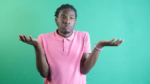 Man Shrugging in Front of Chroma Key Background