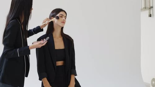 Makeup Artist Applying Makeup to a Model