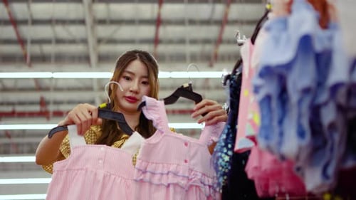 Young Woman Browsing Clothes in Retail Store