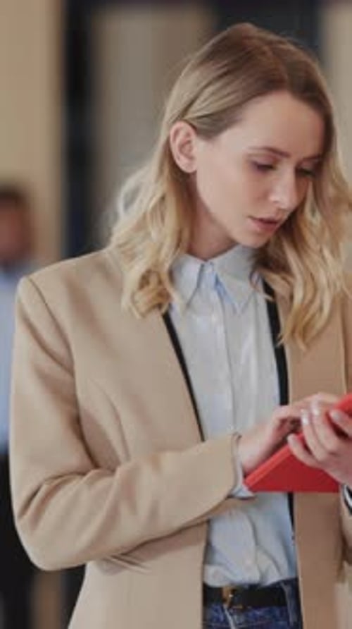 Caucasian Blonde Office Manager Woman Using Tablet Computer Walking in Business Center Coworking