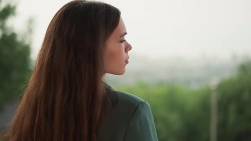Woman with Brown Hair Looking over City