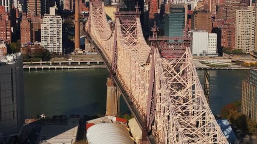 Camera Gliding Forward Over Queensboro Bridge Showcases Cars Traversing the Span East River and