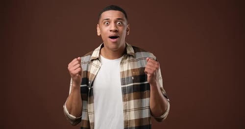 Surprised Young Man Gesturing with Excitement