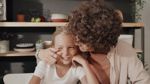Woman and Girl Smiling Together Indoors