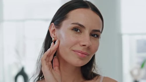 Woman Smiling, Touching Her Face in a Close Up