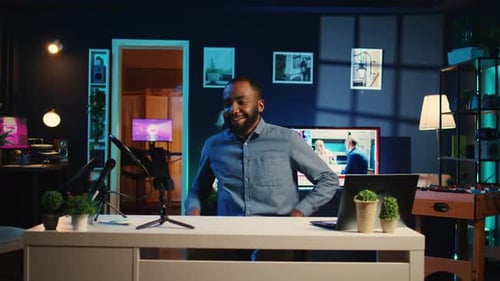 Man at Desk in Home Podcasting Studio