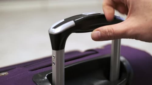 Girl Pushes Handle of Purple Suitcase Up and Goes on Journey