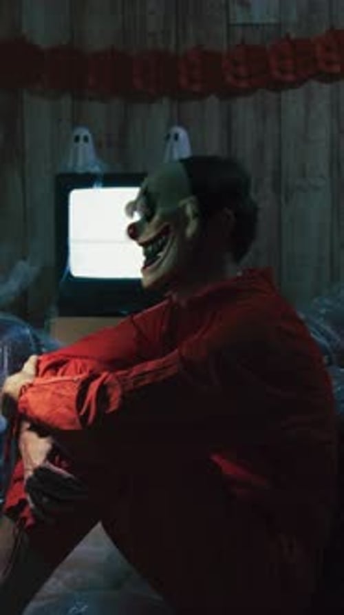 Halloween Party Room With Costumed Clown and Pumpkins