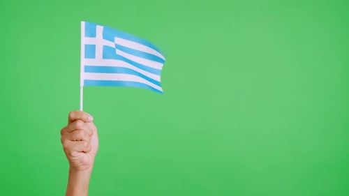 Hand Holding and Waving Greek Flag on Green Screen