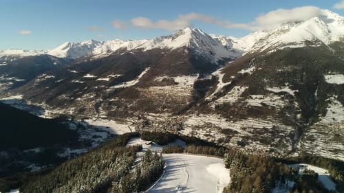 Picturesque high view over alpine ski trail in wintertime. Picturesque canopies of alpine trees. Win
