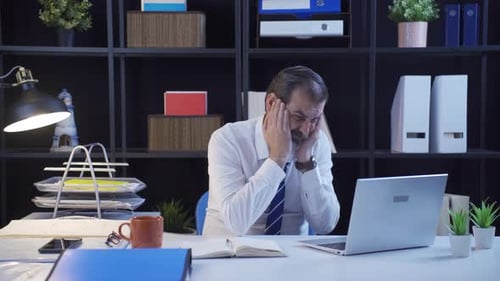 Office worker gets angry and angry as soon as he works on laptop.