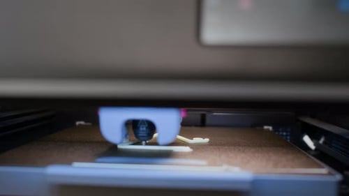 Gros plan de l'extrudeuse appliquant des couches de plastique blanc sur la plate-forme