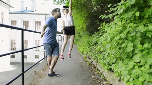 Young couple experiencing virtual reality with vr goggles on a sunny town walk