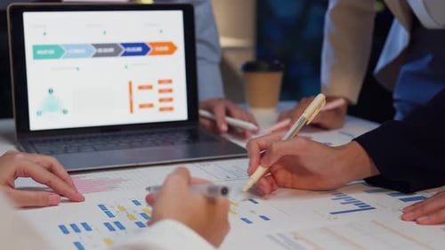 Closeup businesspeople meeting plan analysis statistics brainstorm at office night.