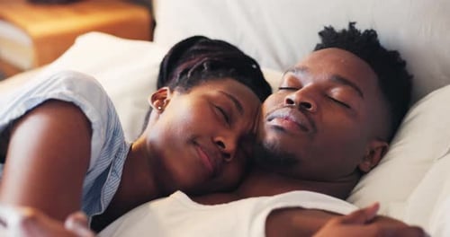 Couple Sleeping Peacefully in Bed Together at Home