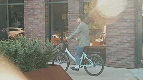 Young Adult Riding a Bicycle in the City