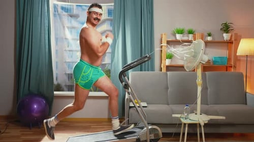 Mustachioed Man Running on Treadmill Indoors