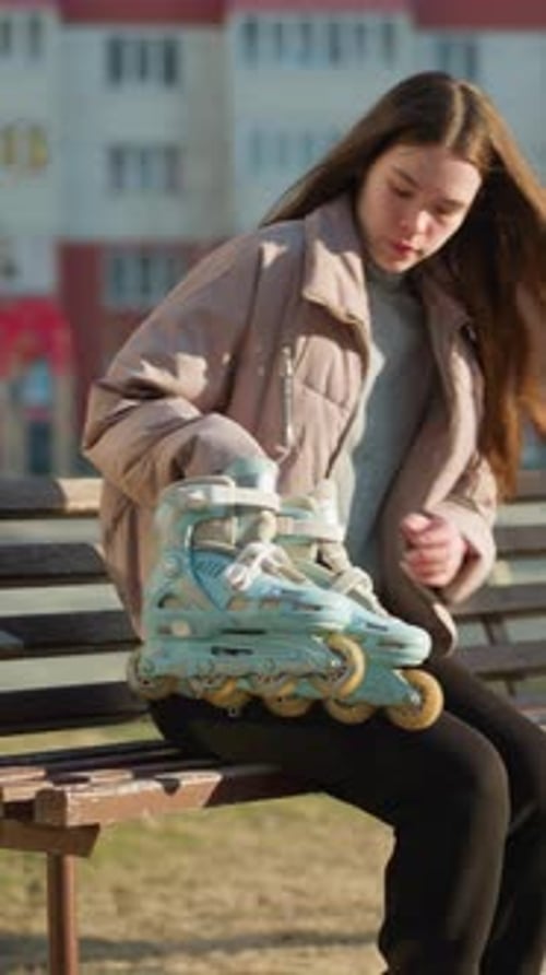 Girl Walking and Sitting on Park Bench with Rollerblades on a Sunny Day