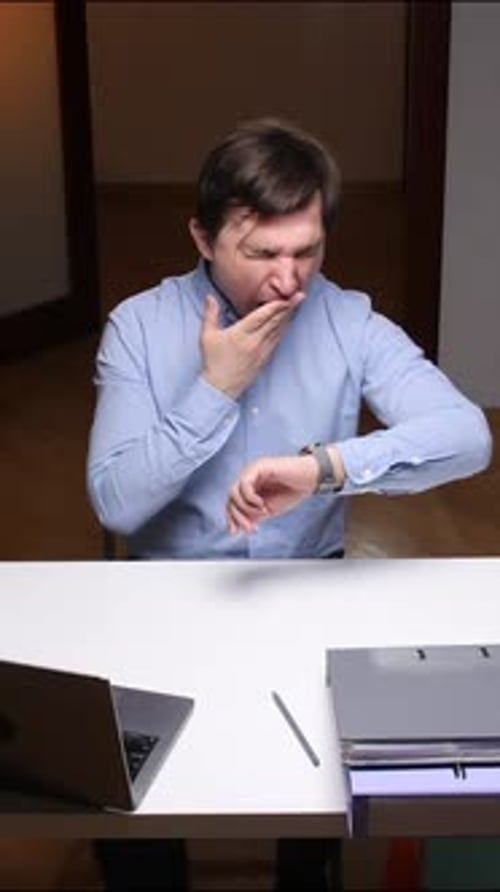 Vertical Video Sleepy Office Worker Yawning and Checking Time at Workplace
