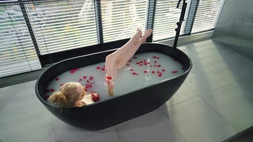 Woman Relax in Bath with Glass of Wine Blonde Girl Resting Lying in Bath with Warm Milk Rose Petals