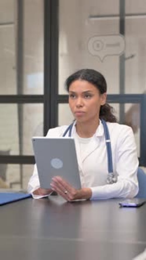 Focused Doctor Working on Tablet in Office Setting