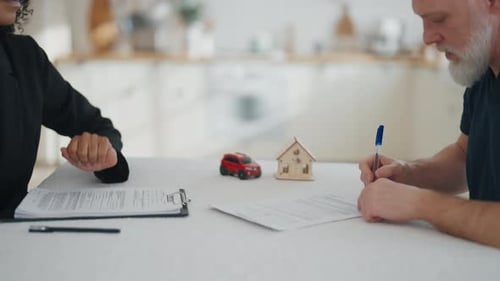 Senior Man Signing Contract of Buying Property Credit for New House or Auto Real Estate or Credit