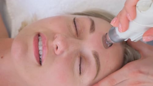 Closeup of a Woman Having a Hydrodermabrasion Facial Peeling Treatment at a Cosmetic Beauty Spa