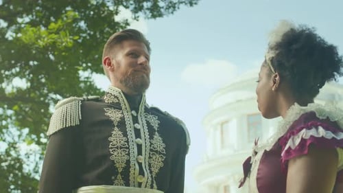 Officer in Ornate Uniform Talking with Lady in Period Dress in Park