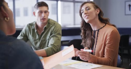 Diverse male and female colleagues in discussion in casual office meeting