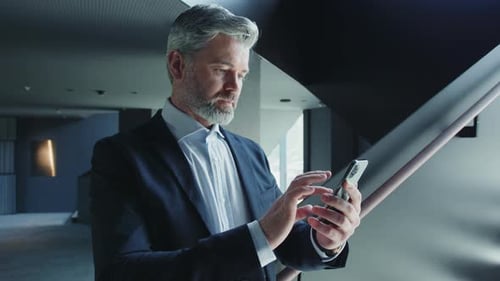 Man Using Smartphone in Modern Urban Interior