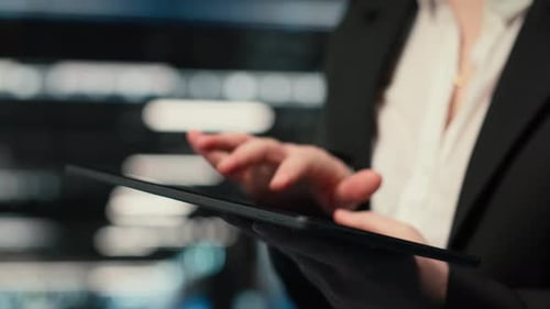 Close Up of Tablet Used By Data Center Admin Troubleshooting Supercomputers