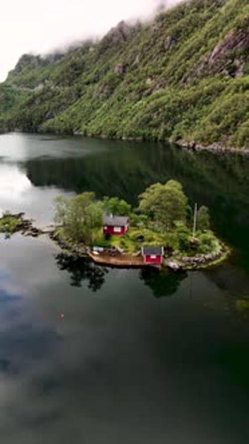 Secluded Island with Red Buildings in Peaceful Water