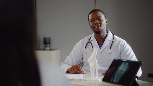 Doctor Discusses X-Ray with Patient in Office