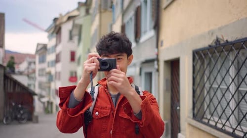Young Man Takes Photo in European City