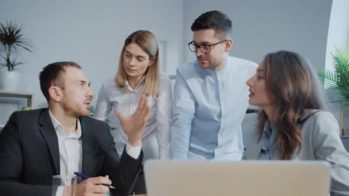 Business Team Meeting at Desk Discussing Ideas