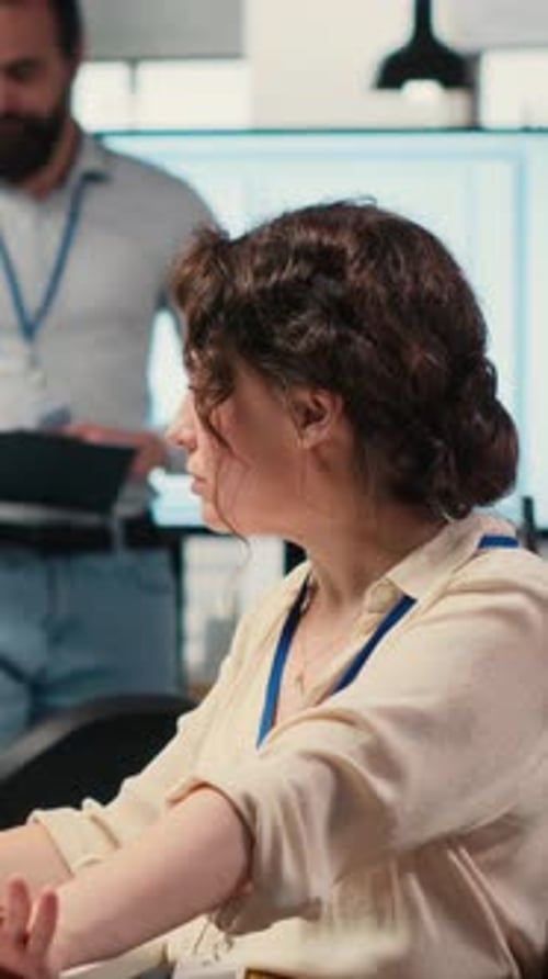 Vertical Video Office Administrator Checking Monthly Reports with AI Analytics Platform