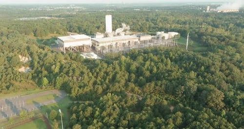 Industrial Facility Amidst Dense Forest in a Rural Area During Daylight Hours