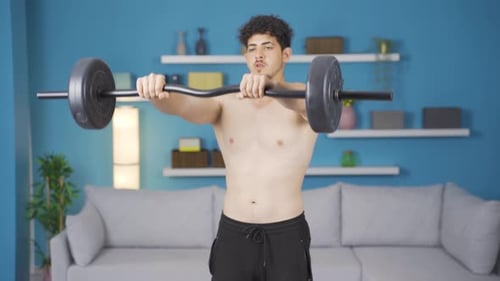 Shirtless Man Working Out with Barbell Indoors