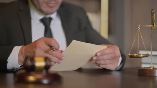Close up of Judge Reading Legal Documents in Court
