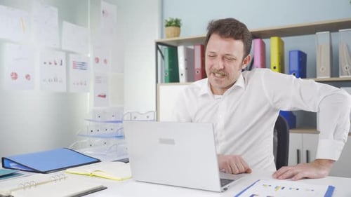 Professional Man Communicating on Laptop in Office
