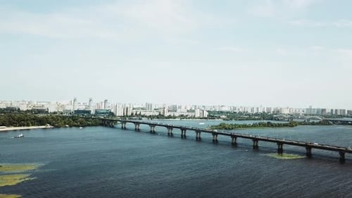 A Stunning Scenic Urban View of a River and Bridge Set Against a Beautiful Horizon