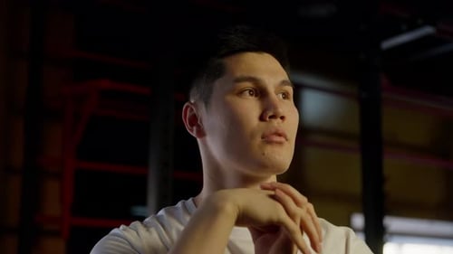 Man in Gym Clasps Hands