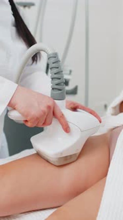 Anticellulite Massage Cosmetologist Makes a Woman Cavitation Vacuum RF Lifting Spa Legs Procedure