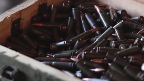 Close-Up of Rifle Bullets in a Wooden Box