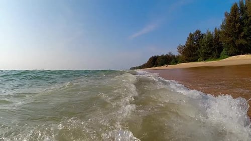 Sea Waves Rolling Onto Sandy Beach of Seashore