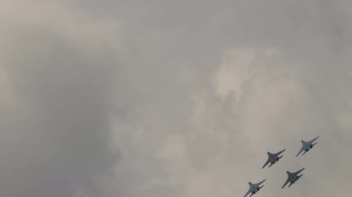 Fighter Jets Flying in Formation Through Cloudy Sky