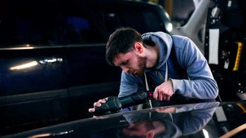 the Car Mechanic at a Service Station Doing the Final Polishing to Shine