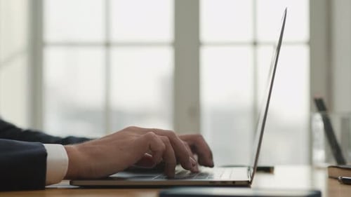 Businessman opens laptop and starts working in office a young success lifestyle