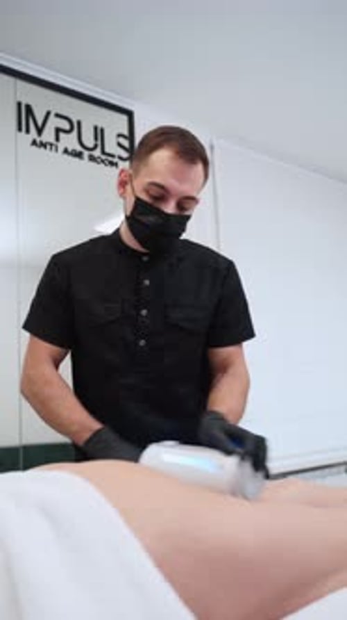 Man Using Beauty Device in Clinic Office