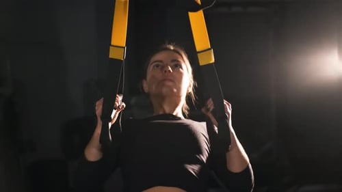 Fitness Woman Workout Exercise with Trx Equipment in the Gym
